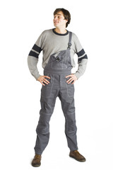 Fototapeta premium A young man in working grey clothes and orange hard helmet painting the walls in the room.