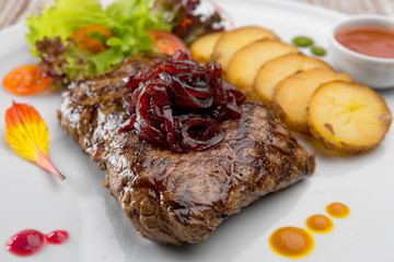 Meat Steak with potatoes on a white plate