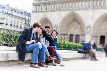Fototapeta premium Multi-ethnic Group Of Friends Having Fun In Paris, Notre Dame