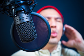 asian handsome male singer singing in recording studio or DJ chatting in radio station, nightclub....