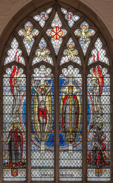 LONDON, GREAT BRITAIN - SEPTEMBER 20, 2017: The Jesus on the cross and as the King on the stained glass in church St. Olave  by A. E. Buss (1953).