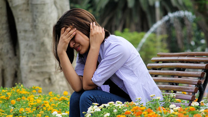 Stressful Female Sitting On Bench