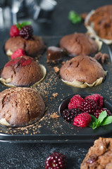 Chocolate homemade muffins with rapsberry on black background