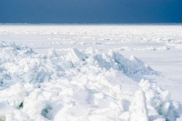 Fototapeta na wymiar Ice sheets knocked together in the north. Sun lit snow. Arctic