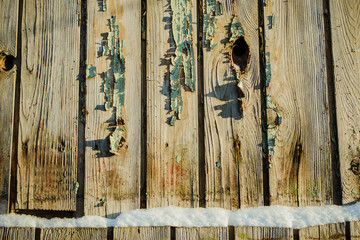 Old wooden boards. The background. Wood texture. Boards with old paint. Wooden fence.