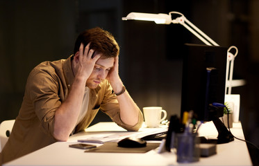 man with computer working late at night office