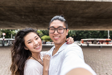 Young Asian Couple Taking Selfie