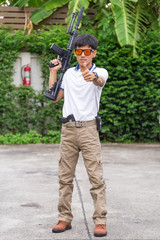 man in cargo pants with gun