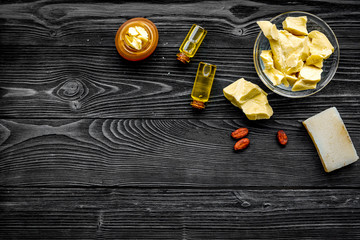 Cocoa butter as ingredient for natural cosmetics. Dark wooden background top view copy space