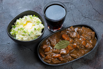 Irish beef and beer stew with champ or mashed potato with green onion, traditional meal for Saint Patrick’s Day, studio shot