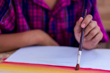 Thai students are testing the use of brushes with poster color.