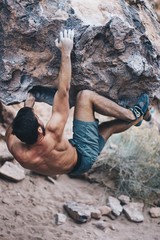 Young Man Bouldering Outside Shirtless