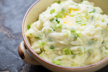 Close-up of Irish champ or potato puree with green onion, one of traditional meals for Saint Patrick’s Day, selective focus