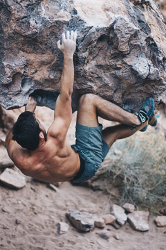 Young Man Bouldering Outside Shirtless