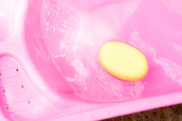 pink basin with spong for take a bath newborn