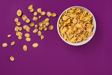 Bowl with cornflakes on the colorful background