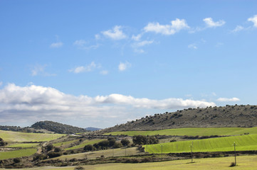 Fototapeta na wymiar Beautiful landscape of gentle hills and harvest fields in spring