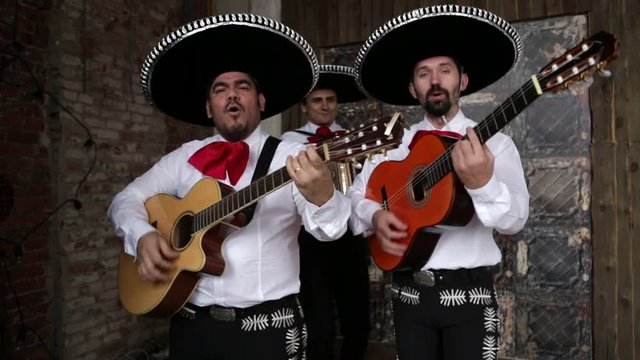 Mexican musician mariachi playing music and sing a serenade
