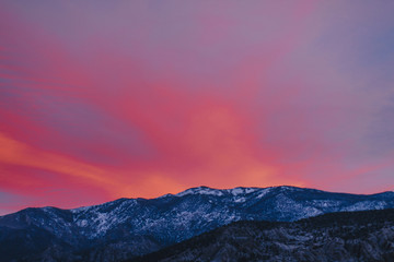 Fototapeta na wymiar Colorful Sunset over Snowy Silhouetted Mountains