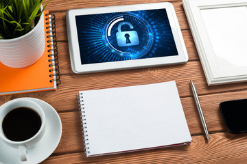 Web security and technology concept with tablet pc on wooden table
