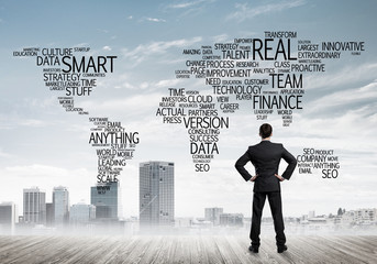 Motivation and inspiration concept with modern cityscape and businessman observing it