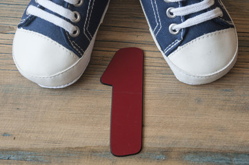 Colorful toddler shoes on wooden background