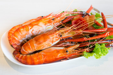 Grilled shrimp,Burn shrimp in white plate on the stone table.