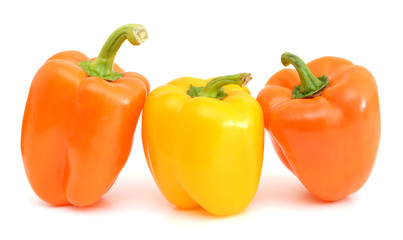 three sweet pepper orange, and yellow with bright green steam with white light and the water drops diet pepper, isolated on white background