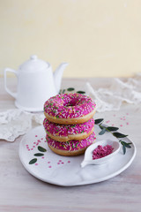 Pink donuts on a white plate for Breakfast