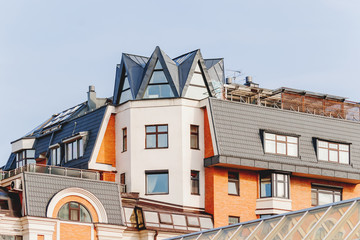 Upper floors and the attic of a house in Moscow, Russia. Interesting attic windows, gables and bay windows.
