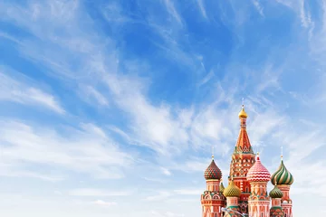 Wall murals Moscow Domes of Saint Basil Cathedral on blue sky background. Famous landmark of Moscow, Russia. Bright sunny day with clouds. Cloudscape on blue sky. Place for text.