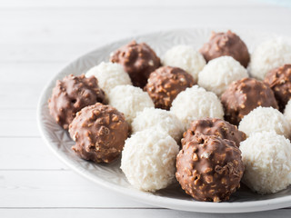 Chocolate and Coconut Candy on a Plate of White background