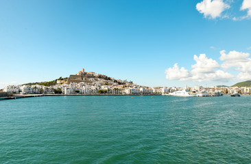 Fototapeta premium Ibiza, Spain - October 5, 2017 : Beautiful view of boat port and old town of Ibiza city and Formentera islands, Spain. Sea rest and holiday concept. View from boat and water. Popular summer resort.