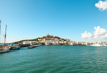 Fototapeta na wymiar Ibiza, Spain - October 5, 2017 : Beautiful view of boat port and old town of Ibiza city and Formentera islands, Spain. Sea rest and holiday concept. View from boat and water. Popular summer resort.