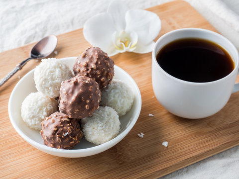 Chocolate and Coconut Candies in a Bowl on a Wooden tray Coffee Cup Orchid.