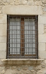 Fototapeta na wymiar Wooden window on stone wall in Girona, Spain