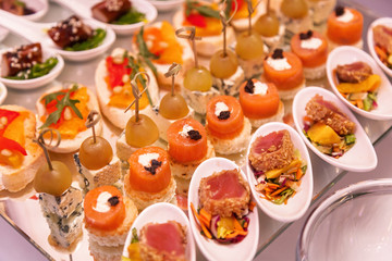 Shrimp with olives, cheese with grapes and canapes with meat. Cocktail Reception
