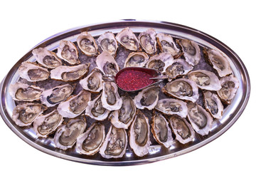 Raw organic oysters with lemon and sauce
