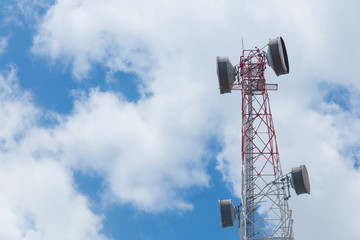 Communication Tower with antenna and satellite dish telecom network on blue sky background.