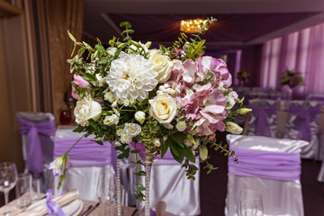 A wedding bouquet is on the table in the background of the hall. Bridal bouquet.