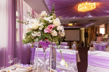 A wedding bouquet is on the table in the background of the hall. Bridal bouquet.