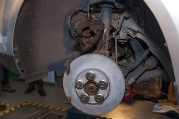Fototapeta premium Disc brake in the car close-up on the side. Disc brake in the car.