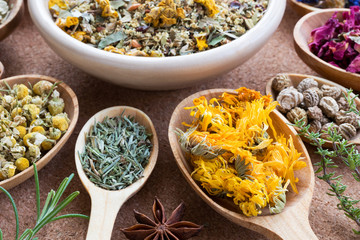 Dried calendula with other herbs in the background