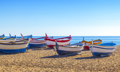Colorful wooden fishing boats on the beach.