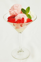 Strawberry ice cream in cup on white background