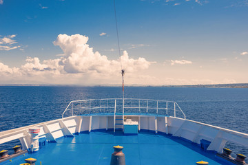 View of the Greek island and little yachts from the ship ferry. Sunset background