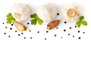 Garlic with parsley leaves and black pepper closeup.