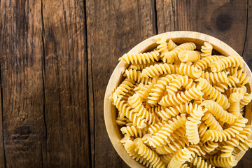 Raw Pasta Fusilli in Wooden Bowl