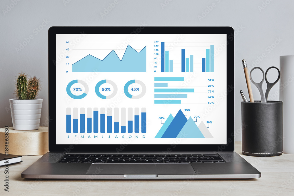 Wall mural graphs and charts elements on laptop screen on modern desk. all screen content is designed by me. fr