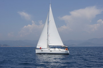 Fototapeta na wymiar Sailing boat Bavaria`11 36 feets float under sail in sunny day. Europe. Mediterranean sea. Sud-western coast of Turkey. May 2012.
